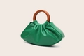 Detail of green pleated PU leather dumpling bag with brown round wooden handle - Green