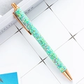 Green glitter retractable ballpoint pen with rose gold metal accents on white tile - Sequin Green