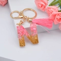 Pink tassel keychain with golden foil and shell crystal resin letter N pendant for bags - Letter N