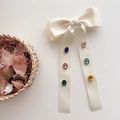 Cream silk double bow hair clip with colorful oval gemstones on a neutral background - Beige With Colorful Gemstone Streamers