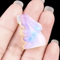 Mini opal rabbit figurine with iridescent glow held on fingertip against black background - Opal (Synthetic)