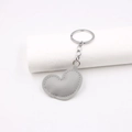Close-up of grey heart-shaped PU leather keychain with metal ring on a white display - Gray