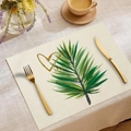 Detail of linen placemat with green palm leaves and golden heart print on dining table - Palm Leaf Golden Heart