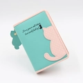 Close-up of cute cartoon cat purse with teal PU leather and pink polka dot details - Short Style / Light Green