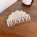Cloud-shaped wavy hair claw in pearlescent white finish on a wooden background - 8.8cm / Mermaid White