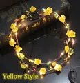Close-up of yellow foam rose LED wreath with micro switch on reflective surface - Yellow