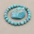 Elastic bracelet with round turquoise beads and natural brown veins on grey surface - Natural Turquoise
