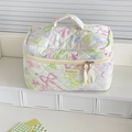 Detailed close-up of quilted butterfly makeup bag with double zippers and ribbon pulls - Dreamy Butterfly Cosmetic Bag - Green