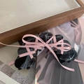 Detail of black marble hair claw clip with a pink ribbon bow on a wooden tray - Black / Approx 8.5x4.5cm