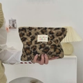 Detailed close-up of leopard print plush cosmetic bag with soft faux fur texture - Brown Leopard