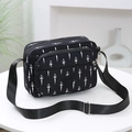 Black nylon crossbody bag featuring white geometric leaf patterns and a SPORT logo emblem - Dandelion