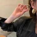 Thick golden hoop earrings for women in minimalist style shown on model for size and scale - 108# Silver Earring Post - Gold - 51mm Diameter
