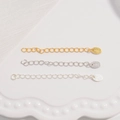 Macro detail of S925 sterling silver extension chains in gold, silver and platinum tones - Round Tag / Gold