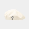 Detail of cream wool beret featuring minimalist black palm tree embroidery on the side - White