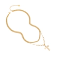 Double-layered gold chain necklace with white pearl cross pendant and lobster clasp detail - Cross