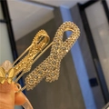 Detailed view of a gold safety pin brooch with sparkling rhinestones and yellow butterfly - Golden Bowknot Butterfly Brooch (7.5cm)