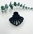 Matte black fan-shaped shark hair claw clip shown on a white surface with leaves - Black