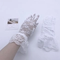 Detailed view of white lace short gloves with elegant ruffled cuffs for Halloween parties - White Lace Gloves