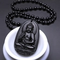 Macro detail of obsidian Buddha amulet featuring intricate Sakyamuni carvings and black beads - Dog/Pig (Amitabha) - Pendant Only