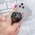 Detail of galaxy phone grip with gold moon and stars on a grey smartphone back - Black Star Moon