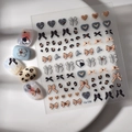 3D embossed nail stickers featuring leopard print and bow designs on a display plate - 5D Relief Leopard Bow Design (CO-139)