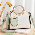 Chic light green and white PU leather handbag with gold ring handle and cat charm - White and Fruit Green
