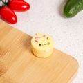 Close-up of yellow round sauce container with cartoon bear face on a wooden board - Rabbit / Beige