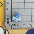 Mini blue resin ocean wave charm for DIY crafts measured on a centimeter scale ruler - Coral/Wave