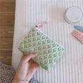 Detailed texture of green canvas coin purse with pink tulip patterns and zip closure - Pink