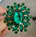 Elegant gold-tone brooch featuring a large oval green faceted gemstone with leaf accents - Xd825239-1 Amazon Bestseller