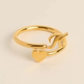 Adjustable golden open ring with letter K and heart element on creamy background - Letter K