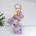 Letter Q purple resin keychain with snowflake sequins, butterfly and tassel charm - Letter Q