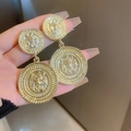 Macro view of gold lion head relief earrings in vintage baroque style for women - Golden Lion Head Round Drop (Silver Pin)