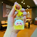 Detail of cute white sheep inside a yellow liquid quicksand acrylic keychain with bell - Yellow Night Light Bubble Beads