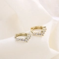 Macro shot of V-shaped gold S925 silver earrings with white cubic zirconia stones - HL-23/Gold V-Shape Row Zirconia Hoop