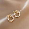 Elegant gold bow earrings with pearl wreath and sparkling crystals on silk background - Gold Bow Pearl Rhinestone Wreath Earrings