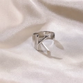 Polished silver ring featuring letter K design on soft silk fabric background - Letter K / Silver
