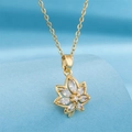 Gold plated maple leaf pendant necklace with shimmering white cubic zirconia crystals - Gold