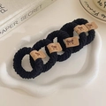 Set of four black high-elastic hair ties with bear tags on a stylish white plate - Black