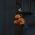 Detail of hand-carved wood fish and lotus pendant with a silky deep green tassel decoration - Aged Cypress Fish Lotus with Tassel