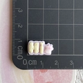 Macro shot of 1.8cm purple resin 'Hi' charm with star on a centimeter measuring mat - Hi Mini Word Plate (5)
