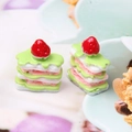 Macro detail of miniature resin strawberry napoleon cake for DIY dessert decor - Matcha + White