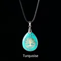 Waterdrop turquoise pendant necklace featuring a golden Tree of Life on black background - Tree of Life Blue Turquoise Pendant