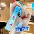 Blue liquid driftwood bottle keychain with white dolphin and star sequins detail - Ocean Creature - Blue Dolphin