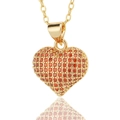 Macro shot of 3D heart pendant with red micro-pave zircons and gold-plated chain - Red