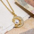 Detailed macro of a gold crescent moon and planet pendant with white pearl and zircons - Gold Moon Planet Pearl Pendant (ZYN-DMK596G-A4)