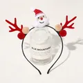 Detailed view of a Christmas headband with reindeer antlers and Santa plush on a glass bottle - Christmas Antler Headband - Santa Claus