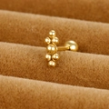 Macro shot of gold cluster bead stud earring with polished finish on velvet stand - Irregular Cluster