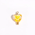 Detail of a handmade heart glass bead pendant in yellow with orange and white patterns - Yellow Heart Shape with Orange Pattern (Style 12)