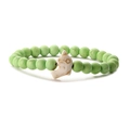 Detail of beaded bracelet with turquoise dolphin pendant and light green synthetic stone beads - Turquoise